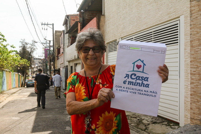 moradora com escritura na mão